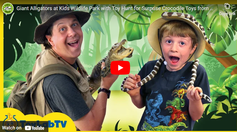 youtube art, man and boy dressed in bush gear holding a toy alligator and snake